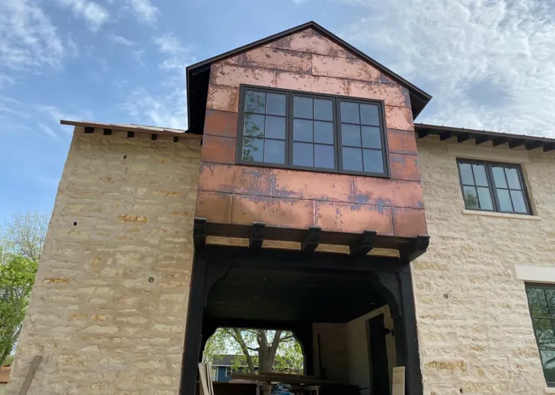Copper metal panel facade on a stone building for Skylight Installation in San Diego